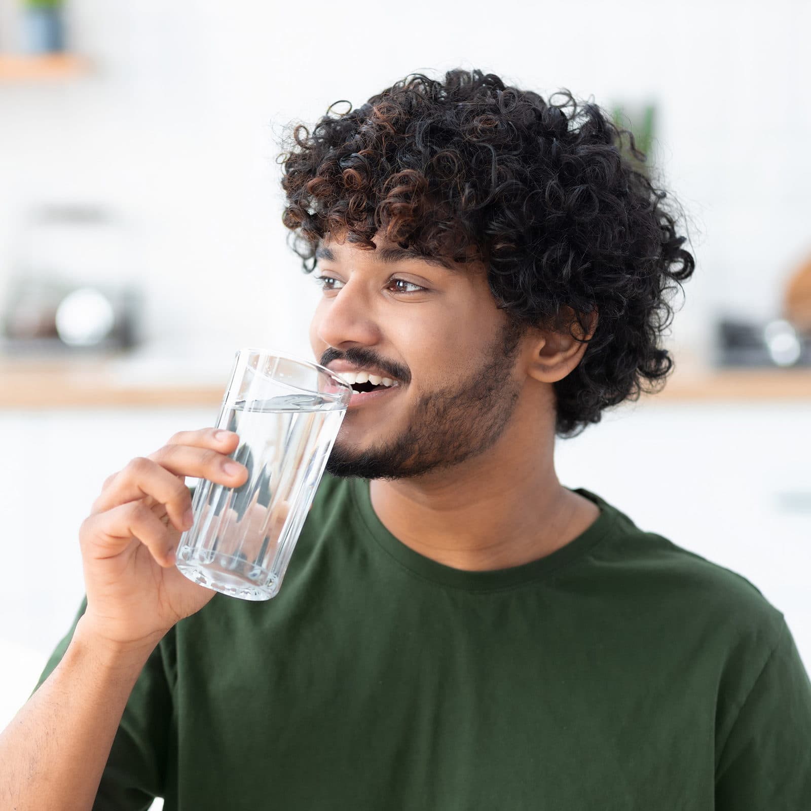 Happy man drinking a glass of water