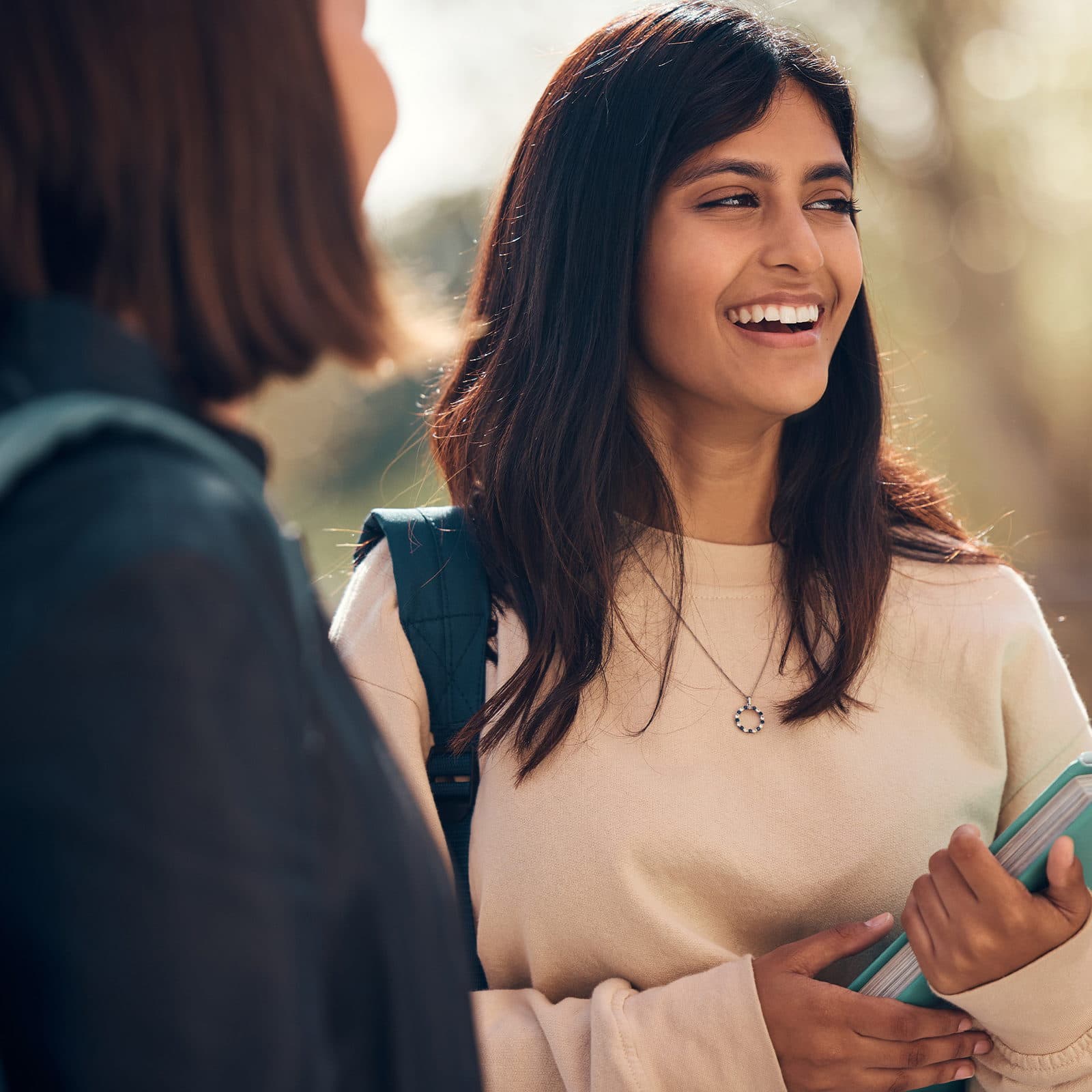 Two women smiling in mid conversation