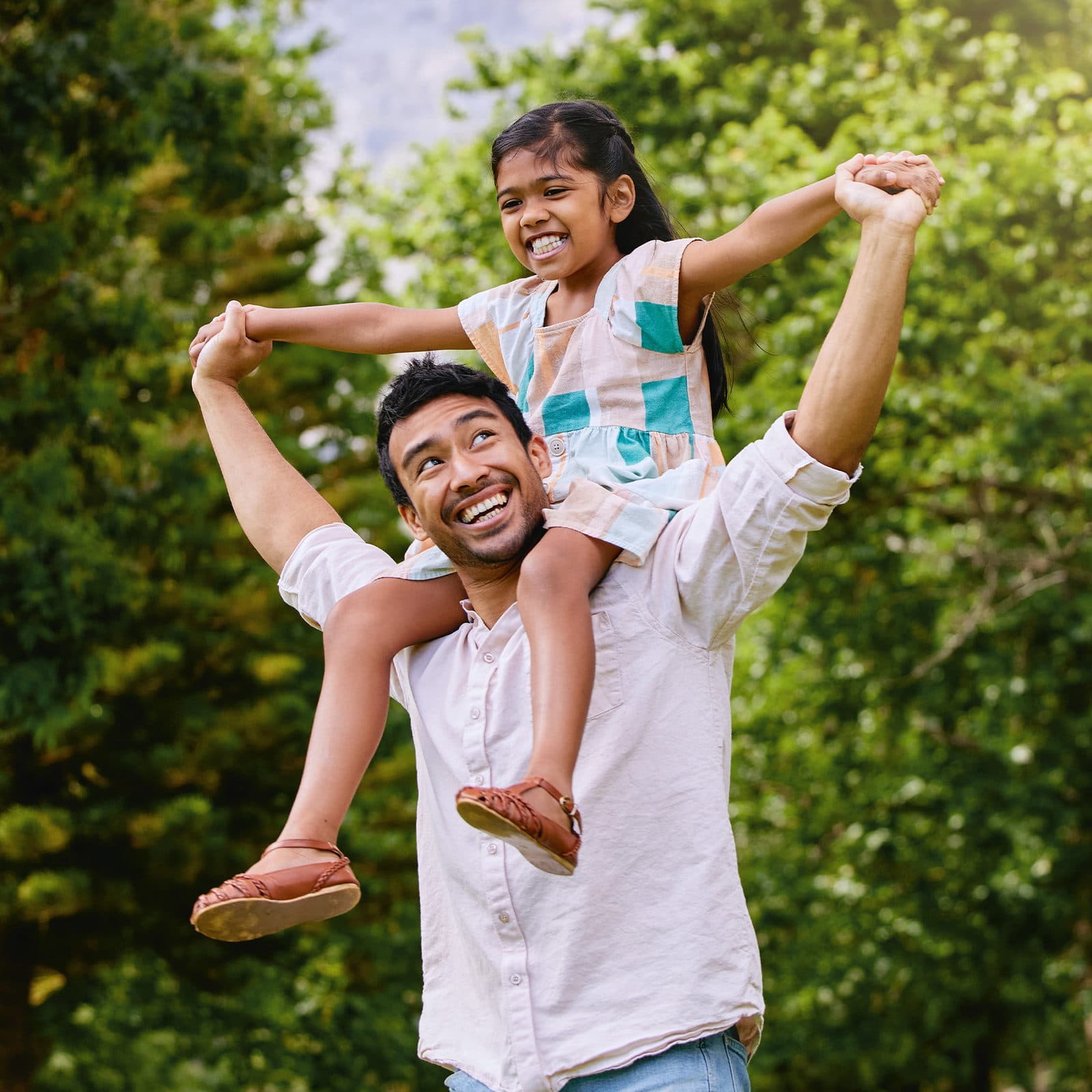 A father and daughter playing in the park
