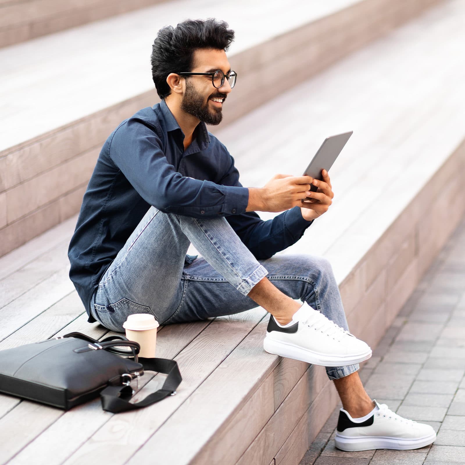 Man on ipad outdoors