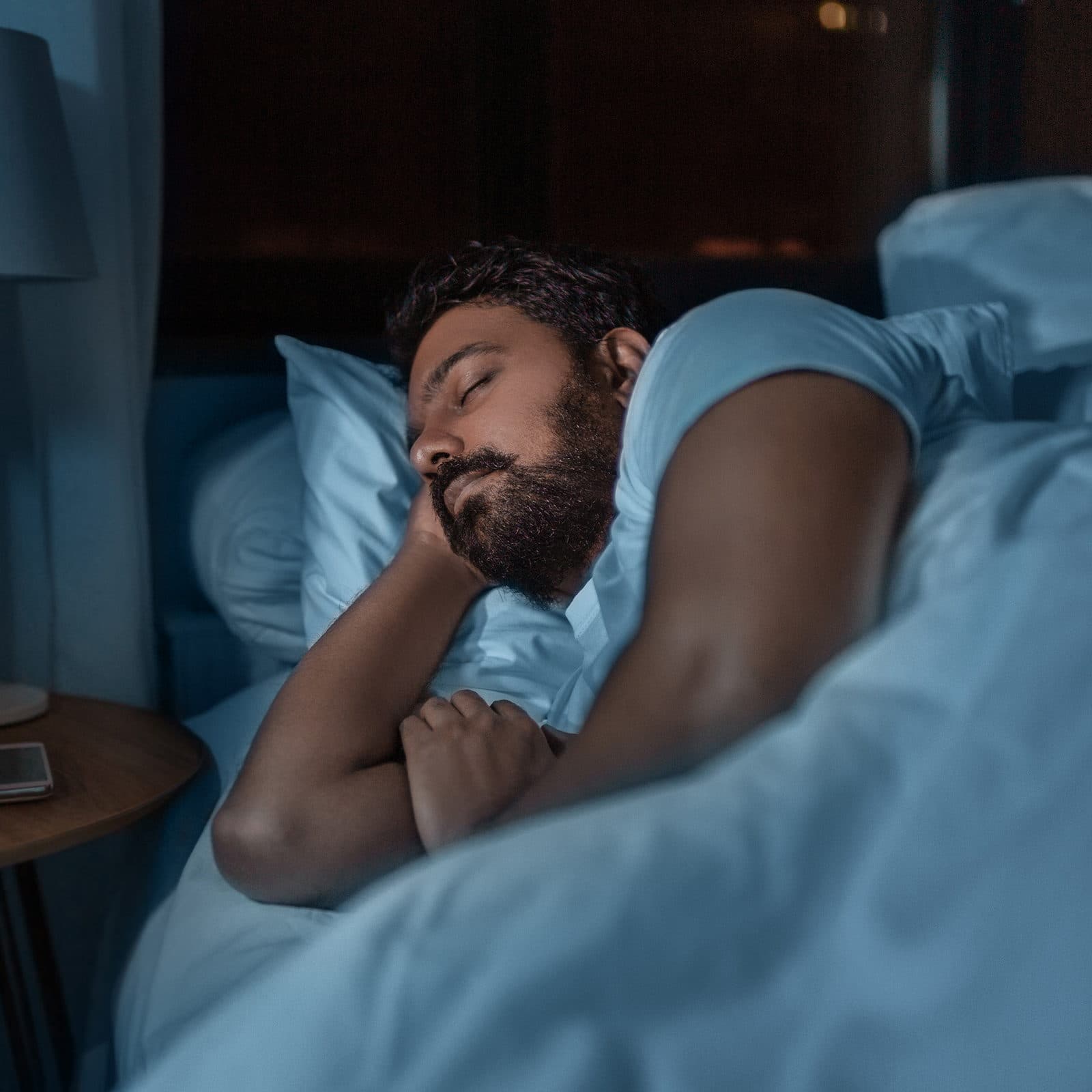 Man asleep in bed