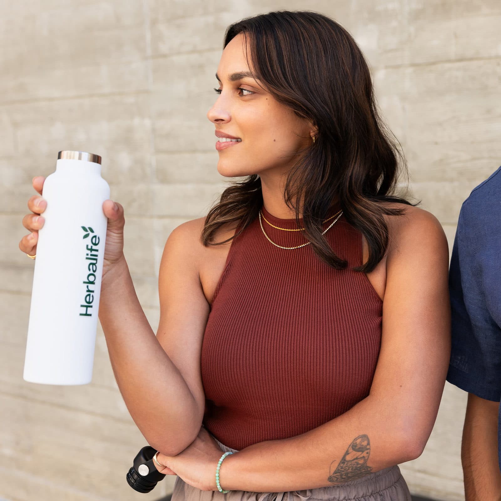 Woman holding white water bottle